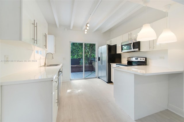 kitchen with beam ceiling, white cabinetry, sink, pendant lighting, and stainless steel appliances