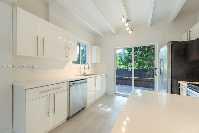11515 NE 12th Ave, Miami, FL 33161 - kitchen with stainless steel appliances, beam ceiling, white cabinets, and light countertops