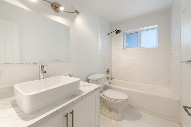 full bathroom with vanity, toilet, tiled shower / bath combo, and tile patterned flooring