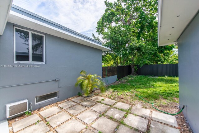 11515 NE 12th Ave, Miami, FL 33161 - view of yard with a patio and a wall mounted AC