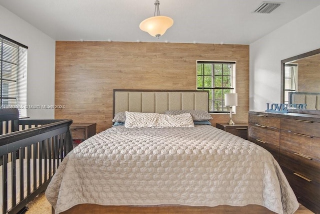 bedroom with wood walls