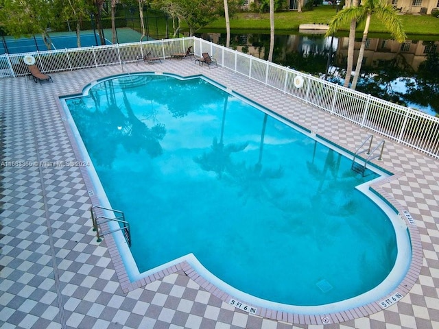 view of pool with a water view