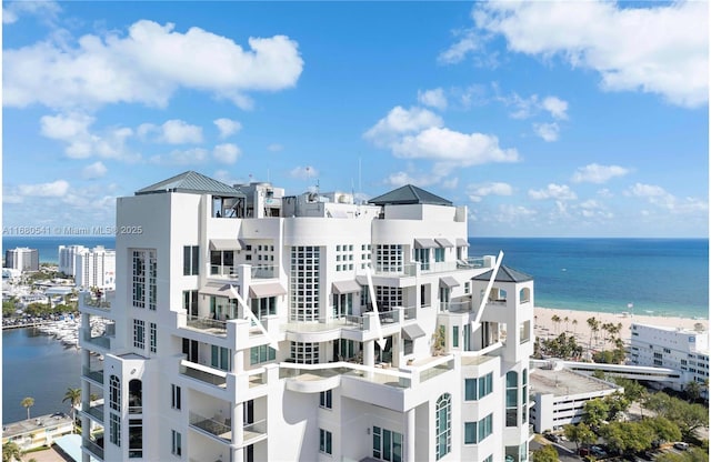 exterior space featuring a water view and a view of the beach