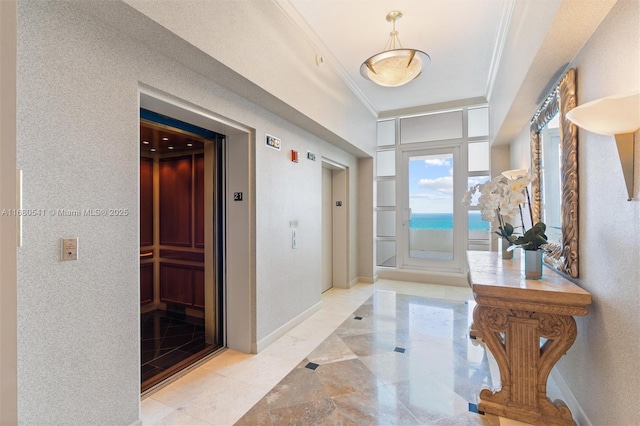 foyer featuring elevator and crown molding