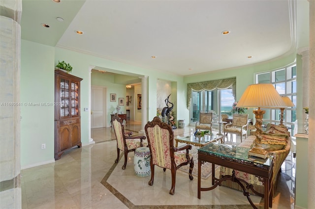 dining area featuring ornate columns and ornamental molding