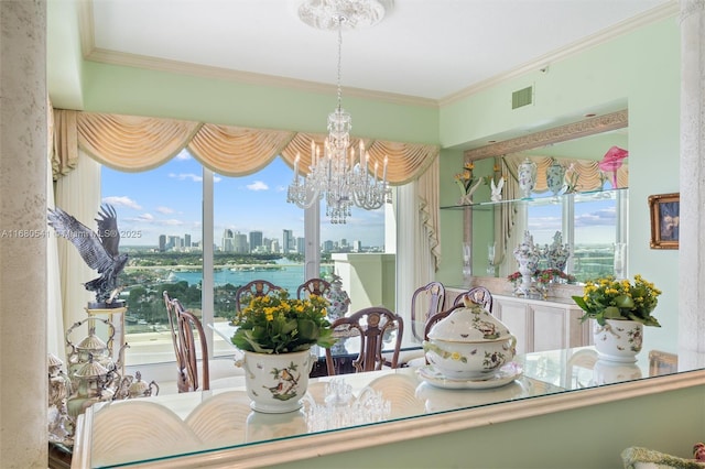 dining room with ornamental molding and an inviting chandelier