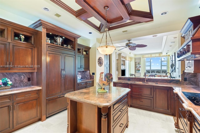 kitchen featuring tasteful backsplash, ceiling fan, crown molding, and sink