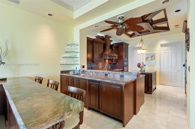 kitchen with hanging light fixtures, a center island, sink, coffered ceiling, and stone counters