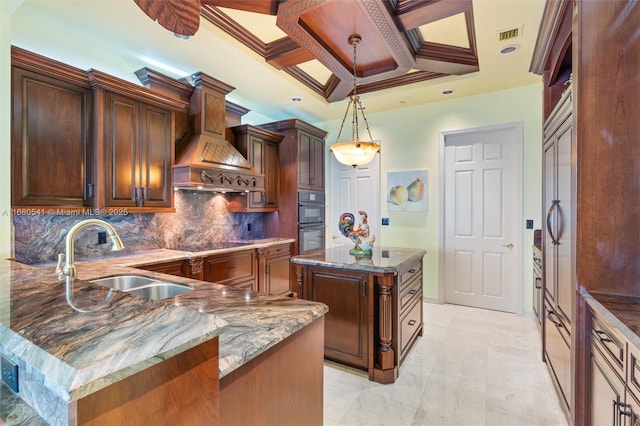 kitchen featuring custom range hood, black appliances, coffered ceiling, a center island, and sink