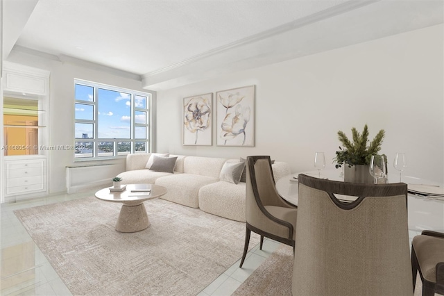 living room featuring ornamental molding and light tile patterned flooring