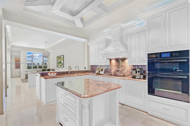 kitchen featuring sink, kitchen peninsula, black appliances, and white cabinetry