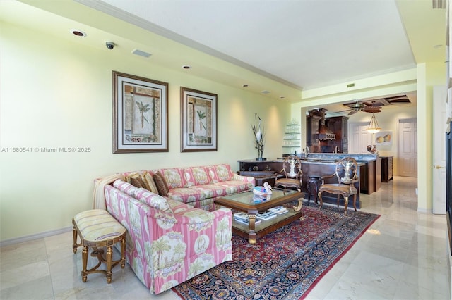 living room with crown molding and ceiling fan