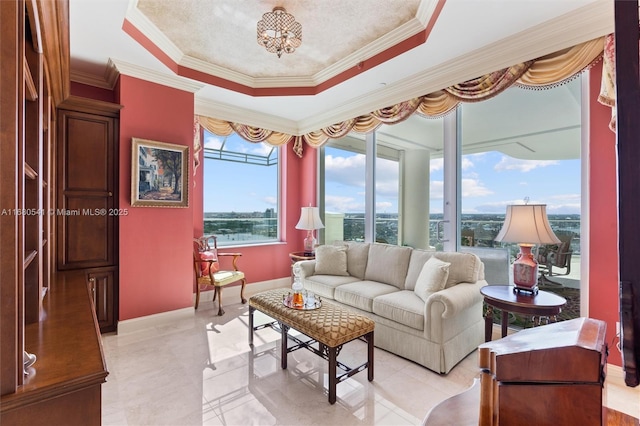 living room featuring a tray ceiling and ornamental molding