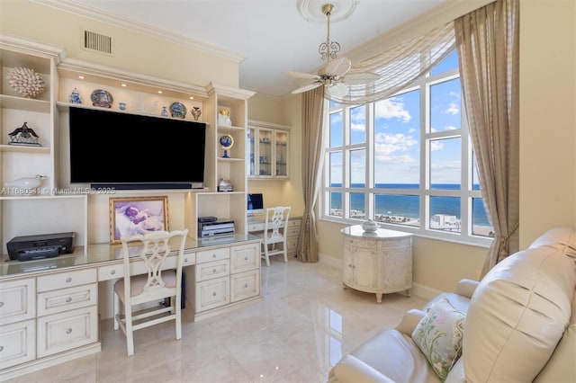 office area featuring ceiling fan, built in desk, and ornamental molding