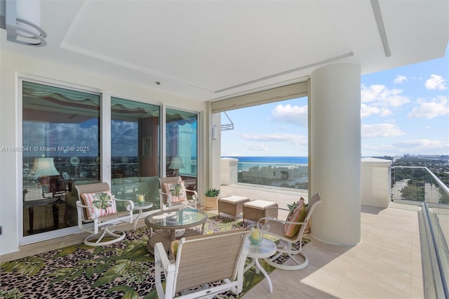 view of patio / terrace featuring a water view and a balcony