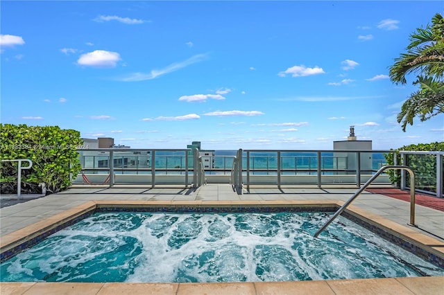 view of pool with an in ground hot tub