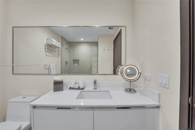 bathroom featuring vanity, toilet, and walk in shower