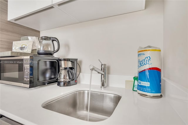 interior details with white cabinets and sink