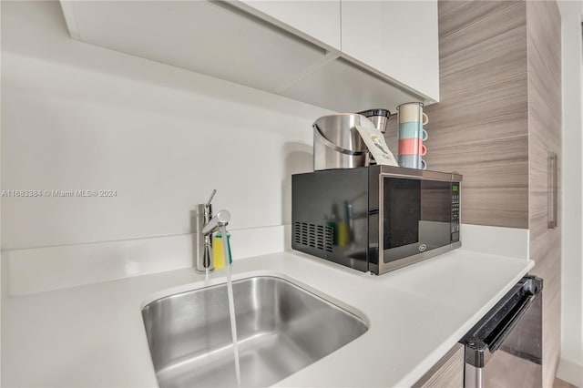 room details with appliances with stainless steel finishes and sink