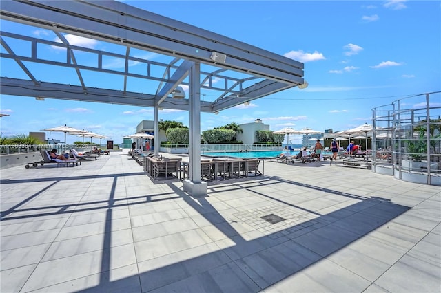 view of patio featuring a community pool and a pergola