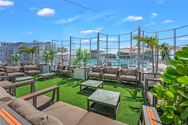 view of patio / terrace featuring outdoor lounge area, a community pool, and a lanai