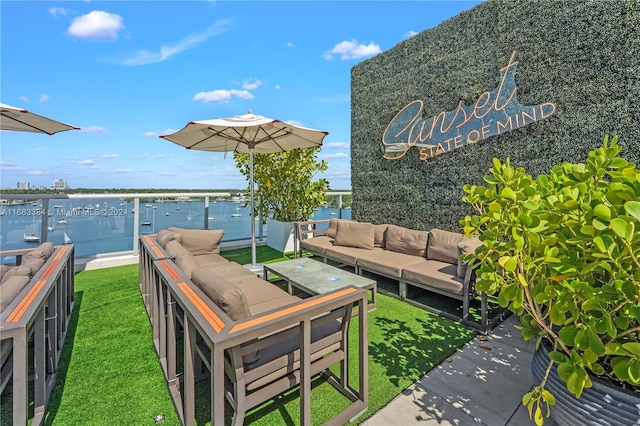 exterior space featuring an outdoor living space, a water view, and a lawn