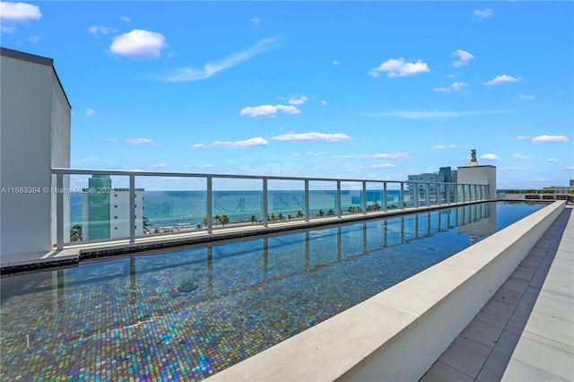 view of pool featuring a water view