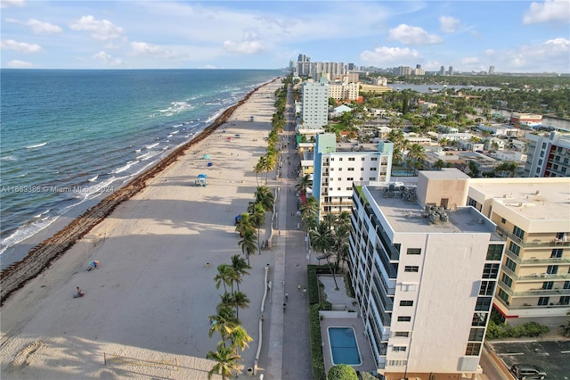 drone / aerial view featuring a water view and a beach view