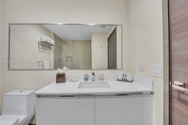 bathroom featuring vanity, toilet, and a shower with door