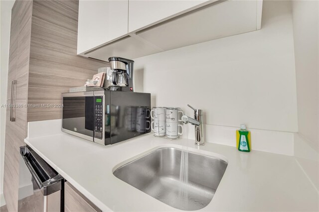 777 N Ocean Dr Unit S316, Hollywood, FL 33019 - kitchen view of stainless steel microwave, light countertops, dishwasher, and white cabinets