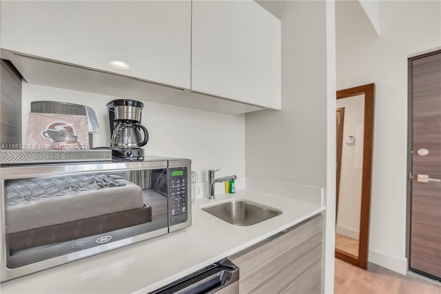 kitchen with sink and white cabinets