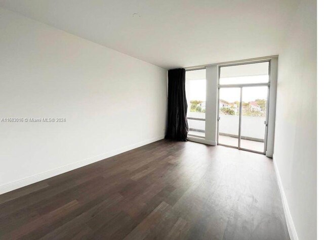 spare room with dark wood-type flooring