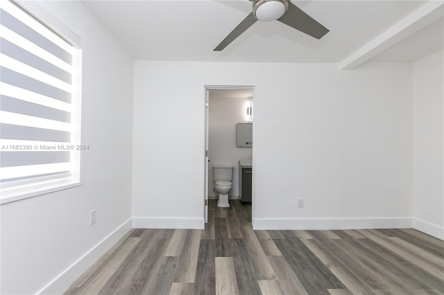 unfurnished bedroom featuring ensuite bath, ceiling fan, and dark hardwood / wood-style flooring