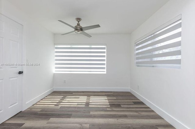 unfurnished room featuring ceiling fan and dark hardwood / wood-style flooring