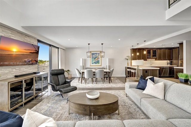 living room with hardwood / wood-style floors and sink