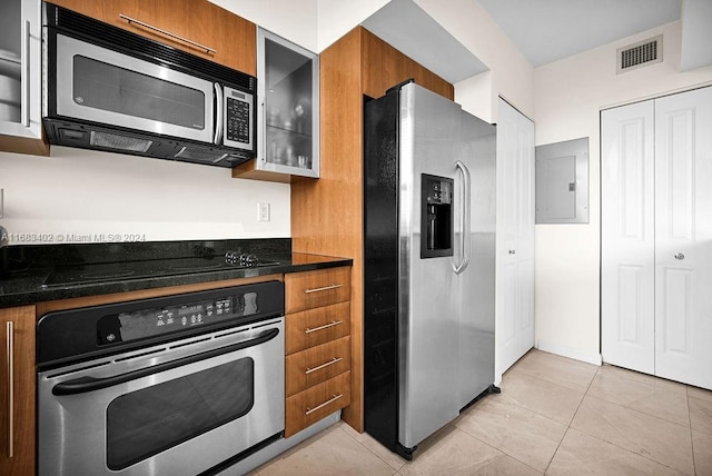 kitchen featuring electric panel, appliances with stainless steel finishes, and light tile patterned floors