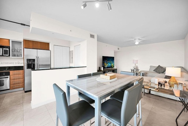 dining room with light tile patterned flooring and ceiling fan