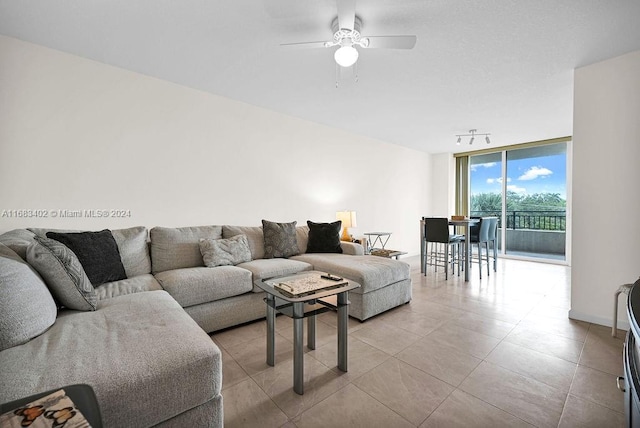 living room with floor to ceiling windows and ceiling fan