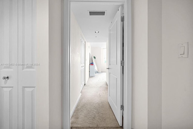 corridor with light colored carpet