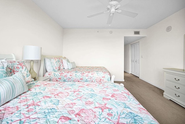 carpeted bedroom featuring a closet and ceiling fan