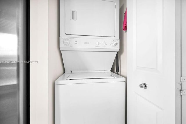 laundry area featuring stacked washer and dryer