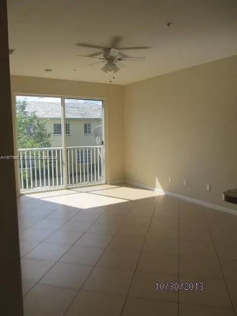 unfurnished room with tile patterned floors and ceiling fan