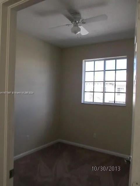 unfurnished room with ceiling fan