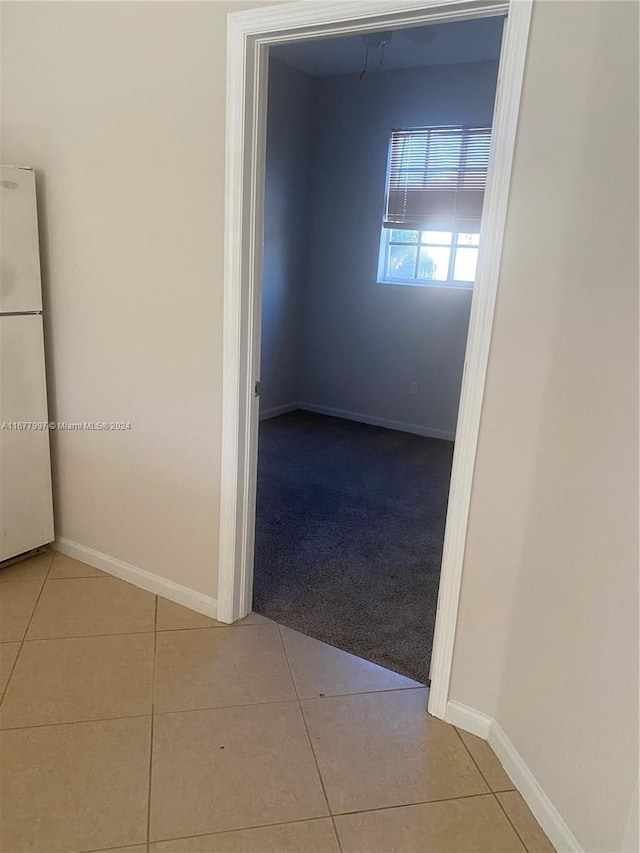 hallway with light tile patterned floors