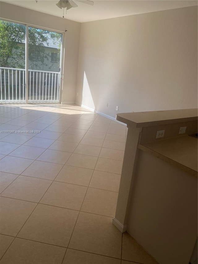 spare room featuring light tile patterned floors and ceiling fan