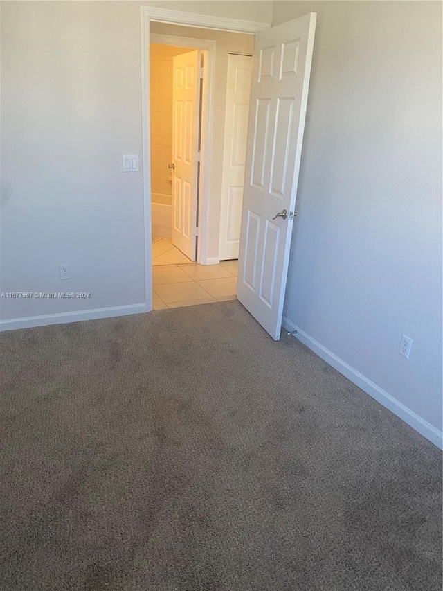 unfurnished room with light carpet