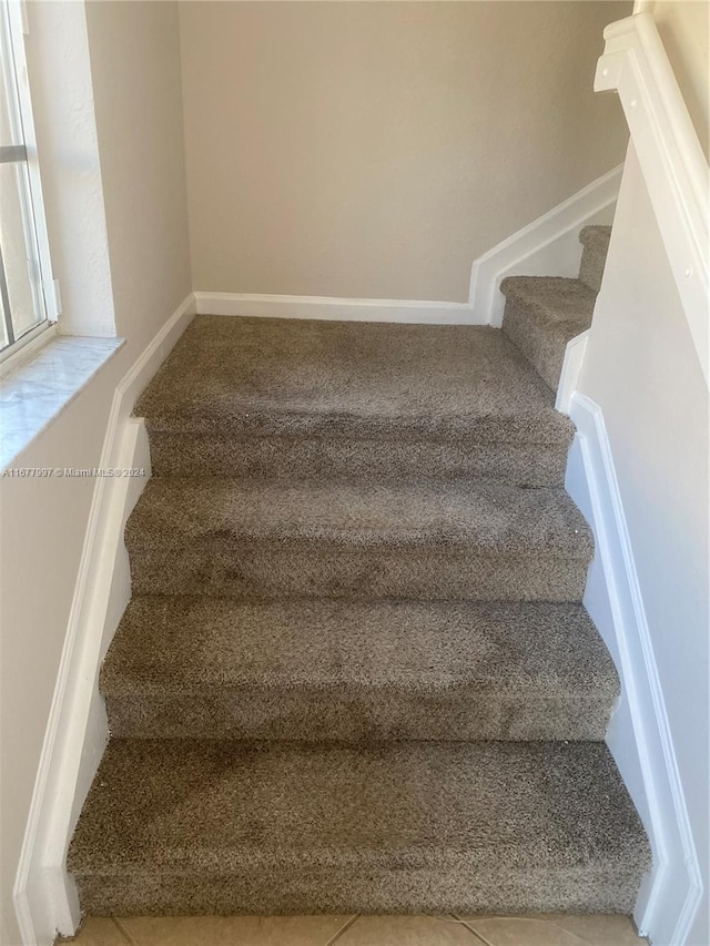 staircase with tile patterned flooring