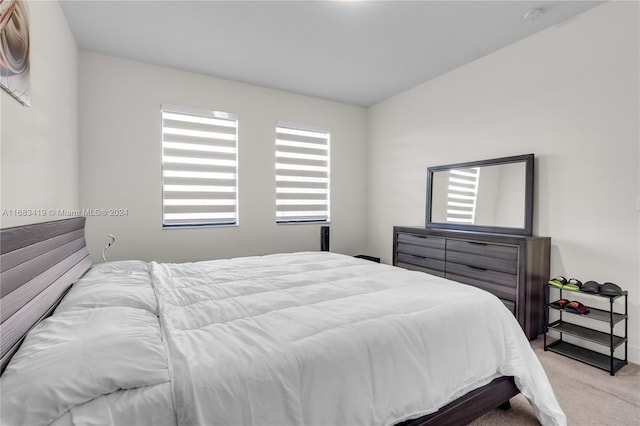 carpeted bedroom with lofted ceiling