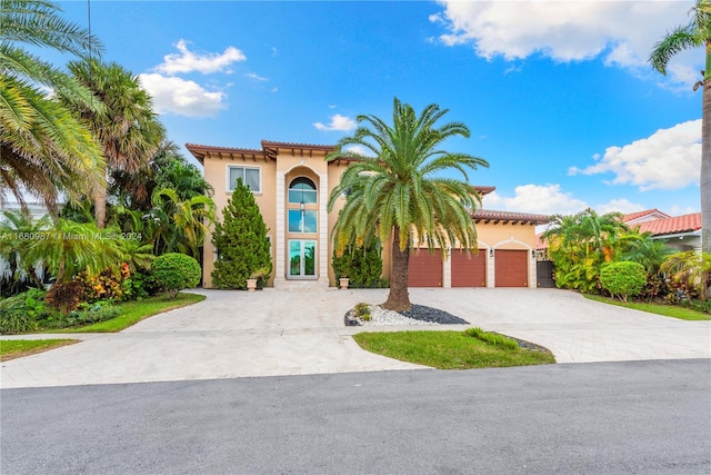 mediterranean / spanish house featuring a garage