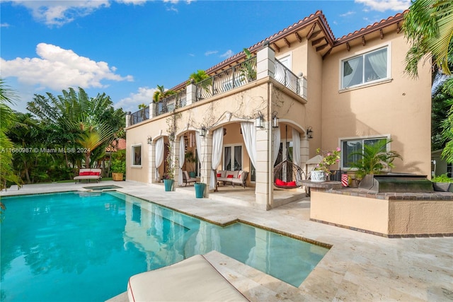 back of property with a patio area and a balcony